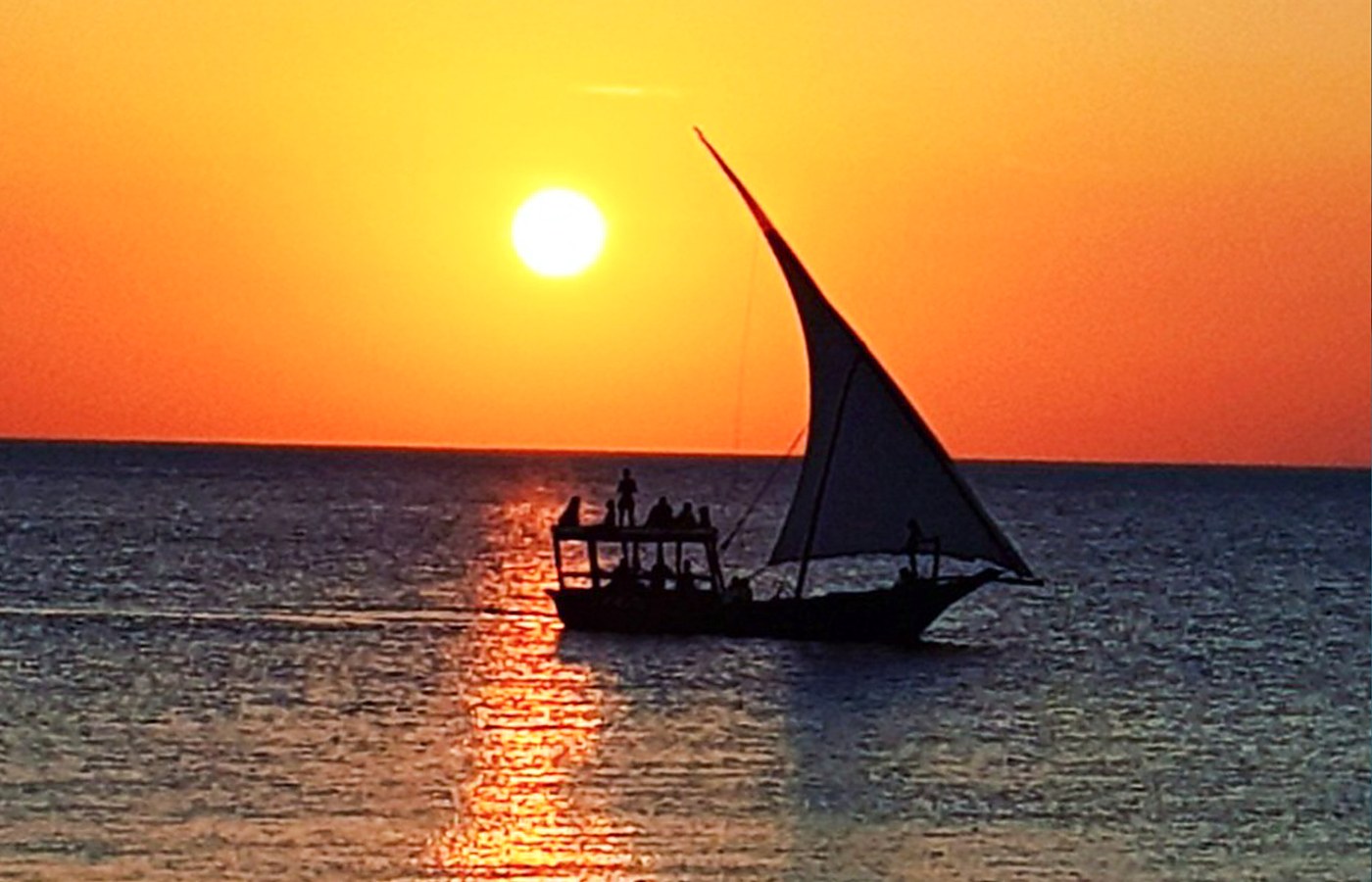 Traditional Zanzibar dhow sailing at sunset