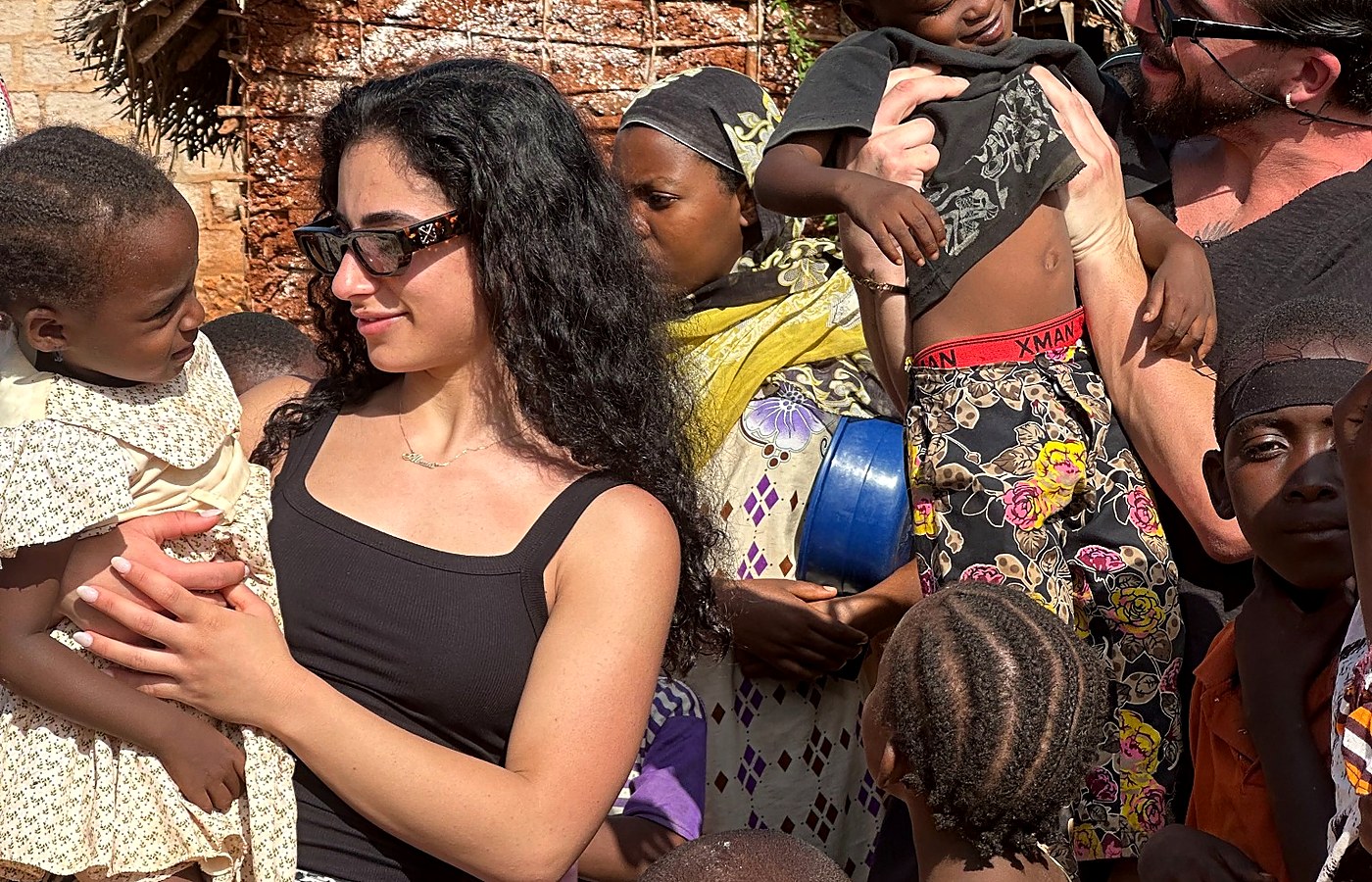 Visitors meeting children and families in a Zanzibar village